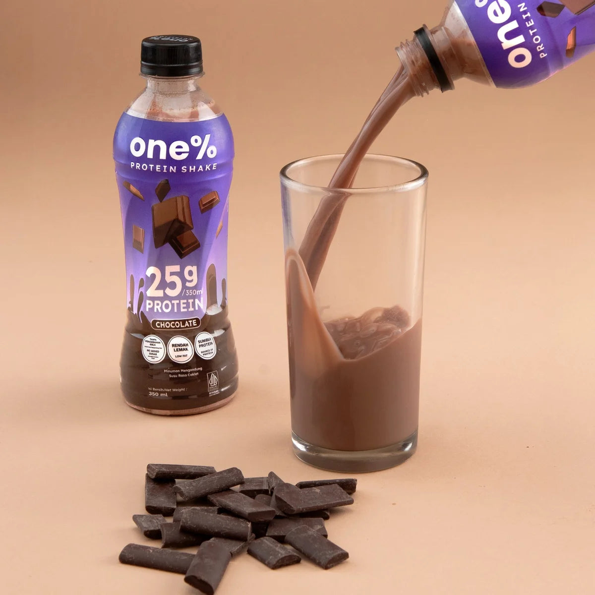 Chocolate Protein Shake poured into a glass, with chocolate pieces